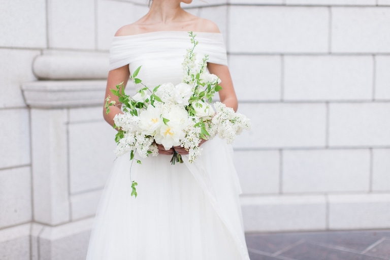 Photo of bride with her white wedding bouquet at the Grand America Hotel.