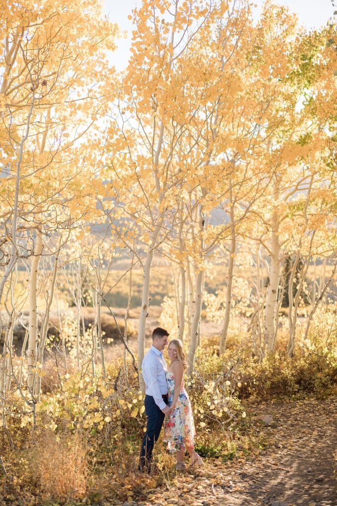 Couple in fall aspen trees at Bonaza Flat in Park City, Utah